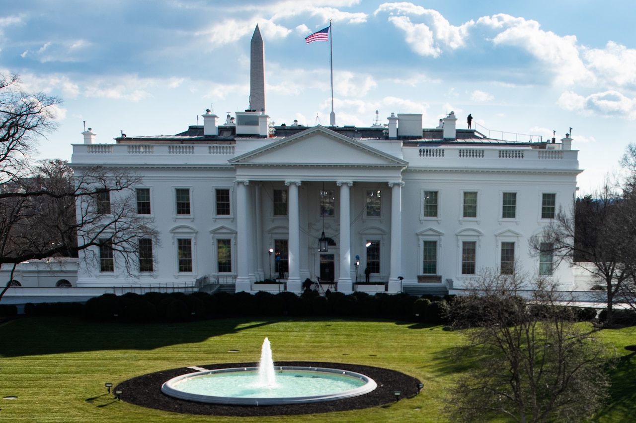 A front view of the White House and surrounding grounds.