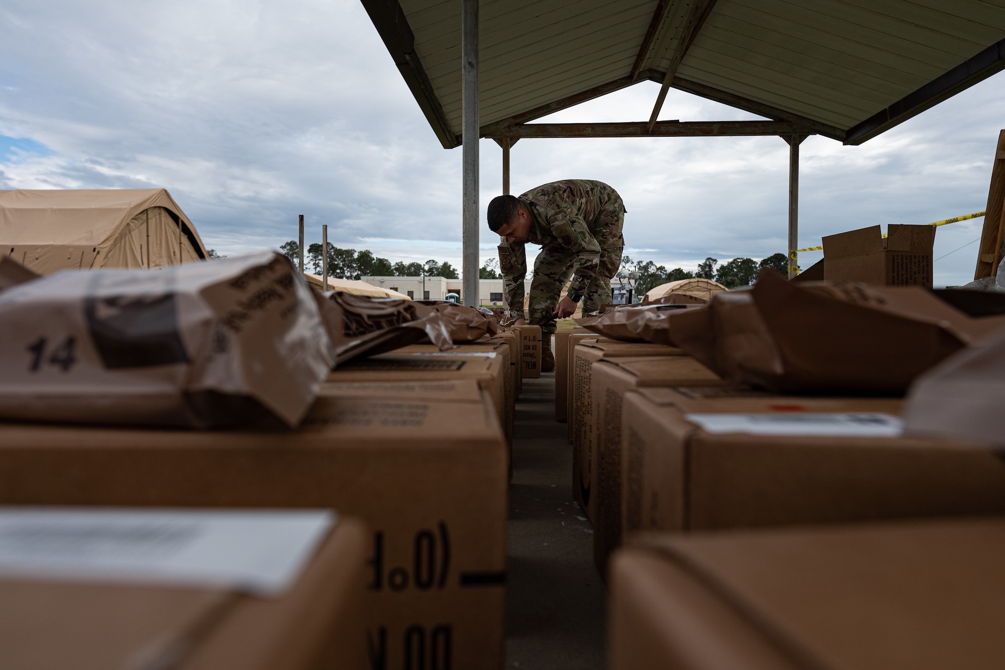 A photo of an Airman unpacking Meals, Ready to Eat