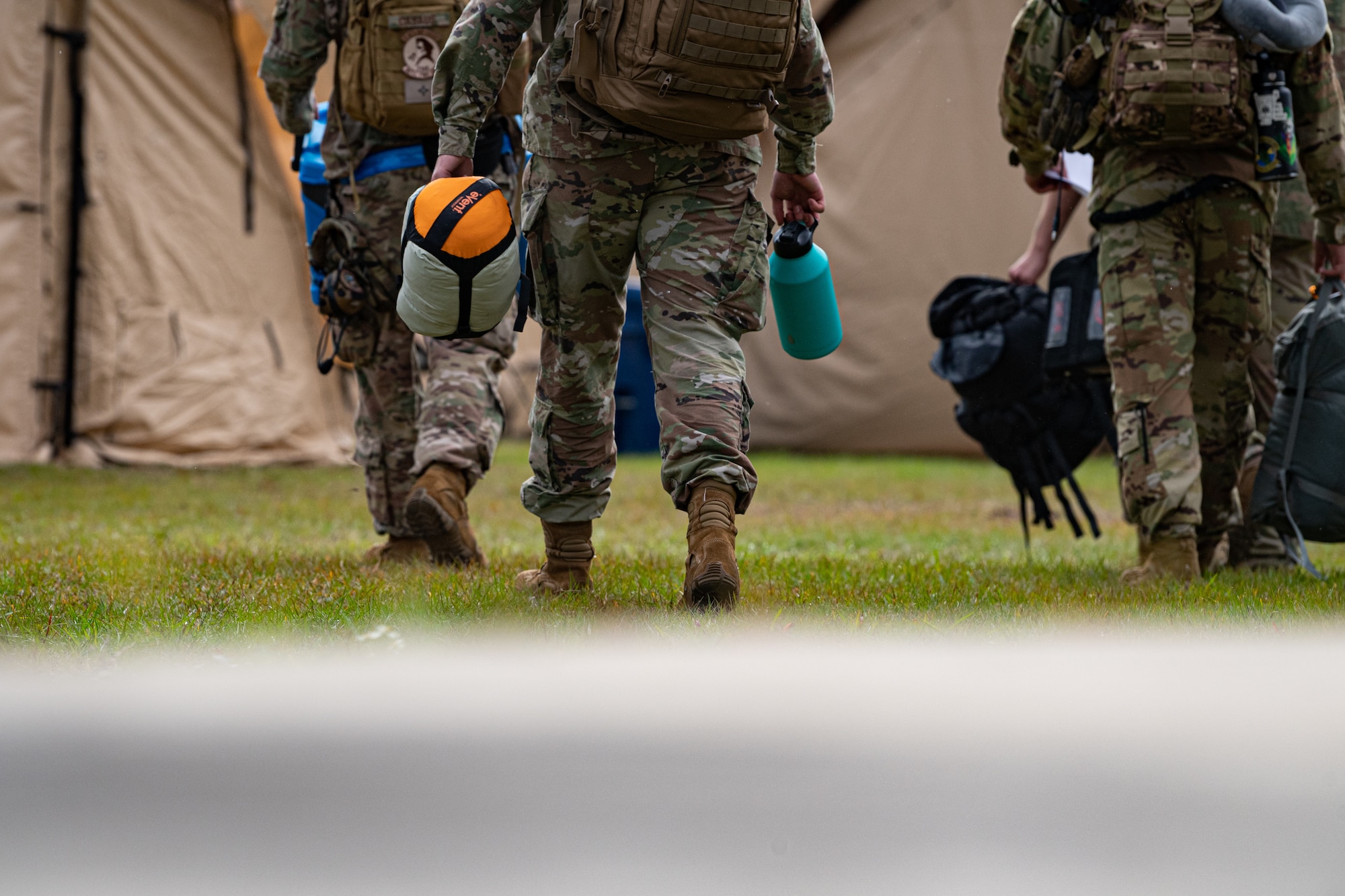 A photo of Airmen walking to their tents
