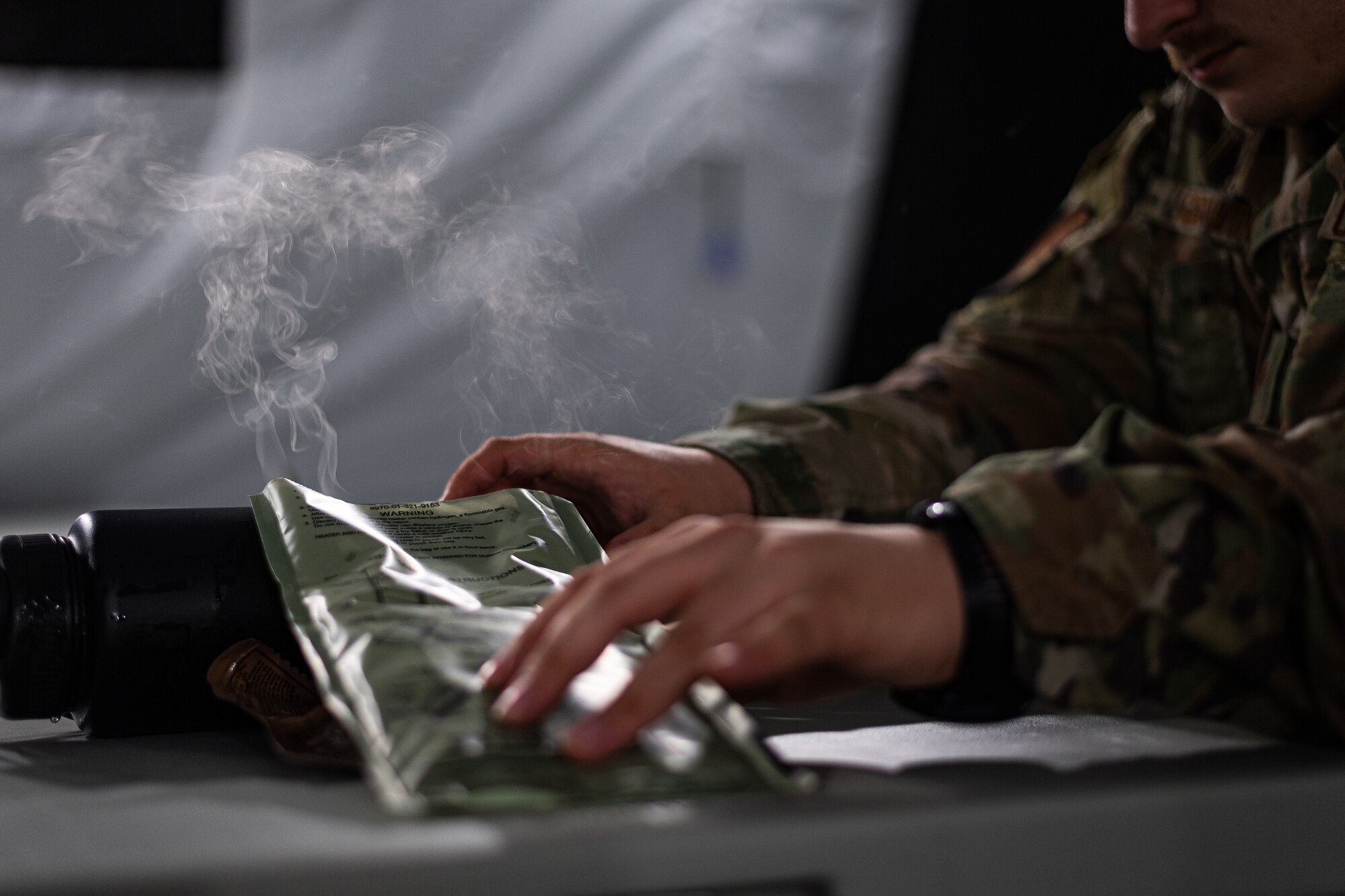 A photo of an Airman preparing a Meal, Ready to Eat