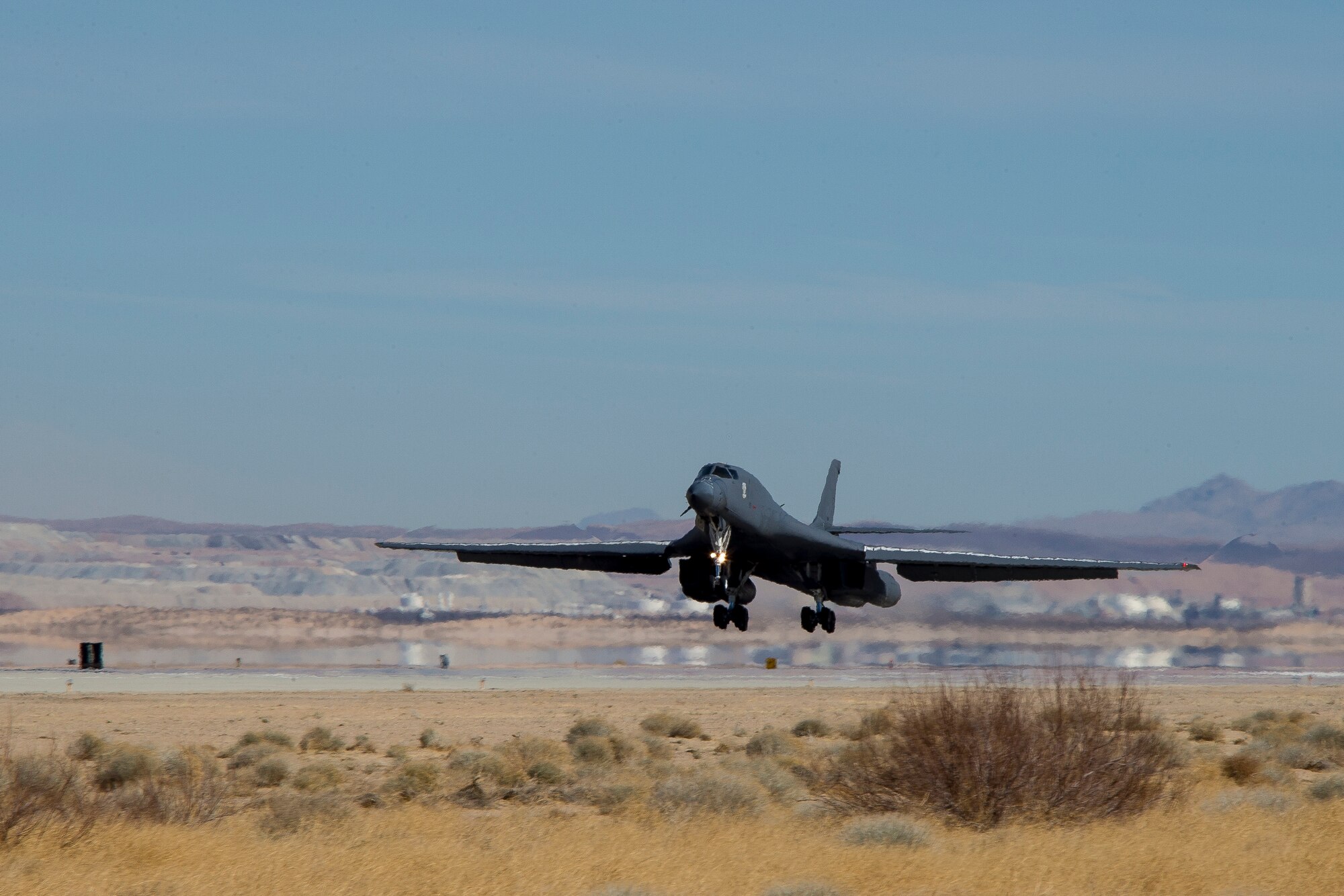 A recently retired B-1B Lancer, tail number 86-0099, lands at Edwards Air Force Base, California, Feb. 23. The aircraft will become the Edwards Aircraft Ground Integration Lab, or EAGIL, a non-flyable aircraft that will be used as an integration lab for future upgrades. (Air Force photo by May Straight)