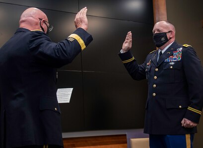 Newly promoted Col. Ronald W. Bonesz, of Normal, Illinois, recites the oath of commissioned officers administered by Maj. Gen. Michael Zerbonia, of Chatham, Illinois, Assistant Adjutant General – Army, Illinois National Guard, and Commander, Illinois Army National Guard.