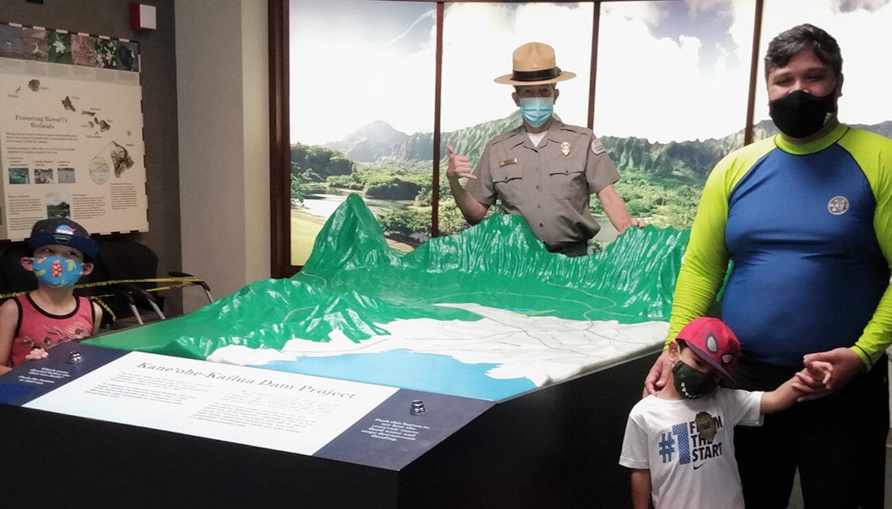 Visitors Exploring an Interpretive Topographic Map of a Mountainous Region of Hawaii