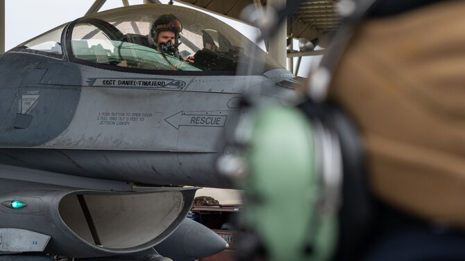Photo of a pilot sitting in the cockpit of an F-16 Viper before being marshalled out.