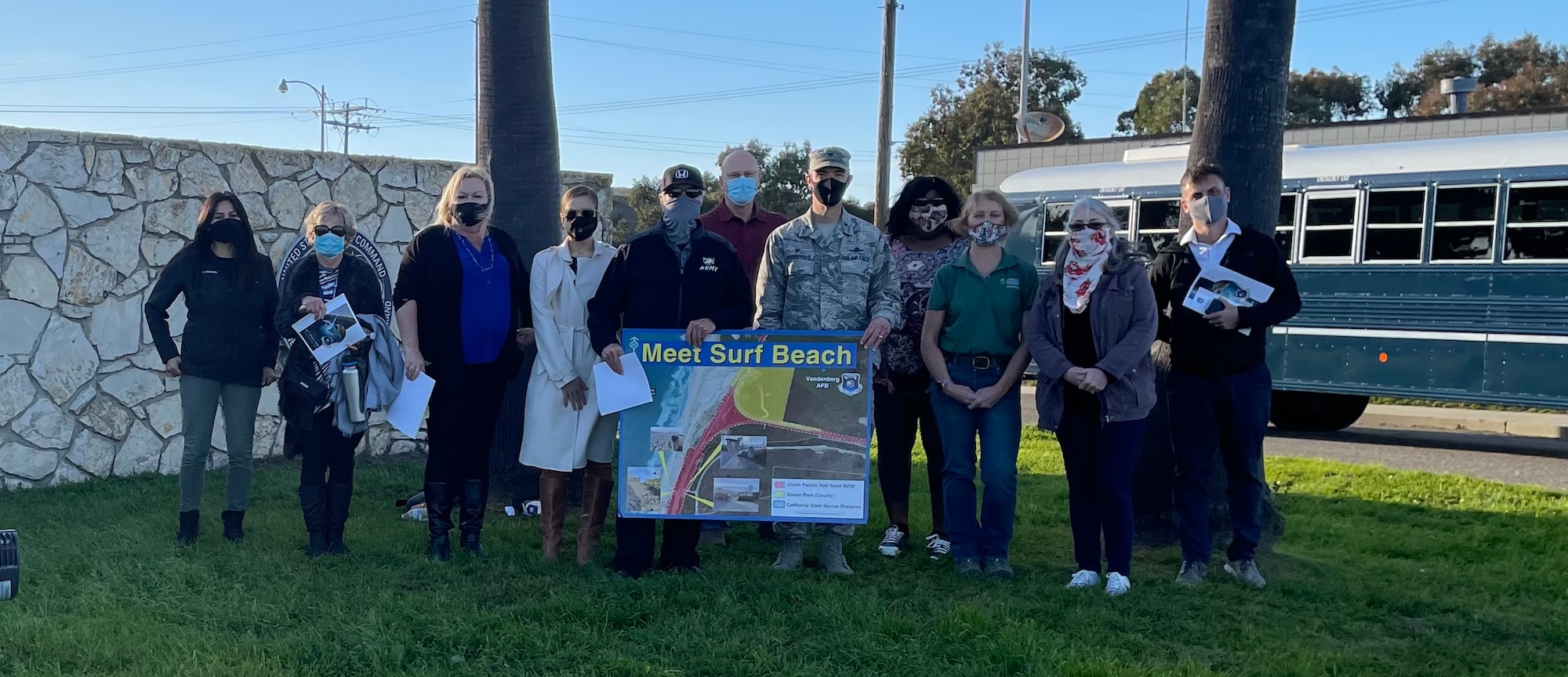 Vandenberg Leadership stands outside Vandenberg South Base gate with "Meet Surf Beach" sign following the community engagement on Feb. 25, 2021.