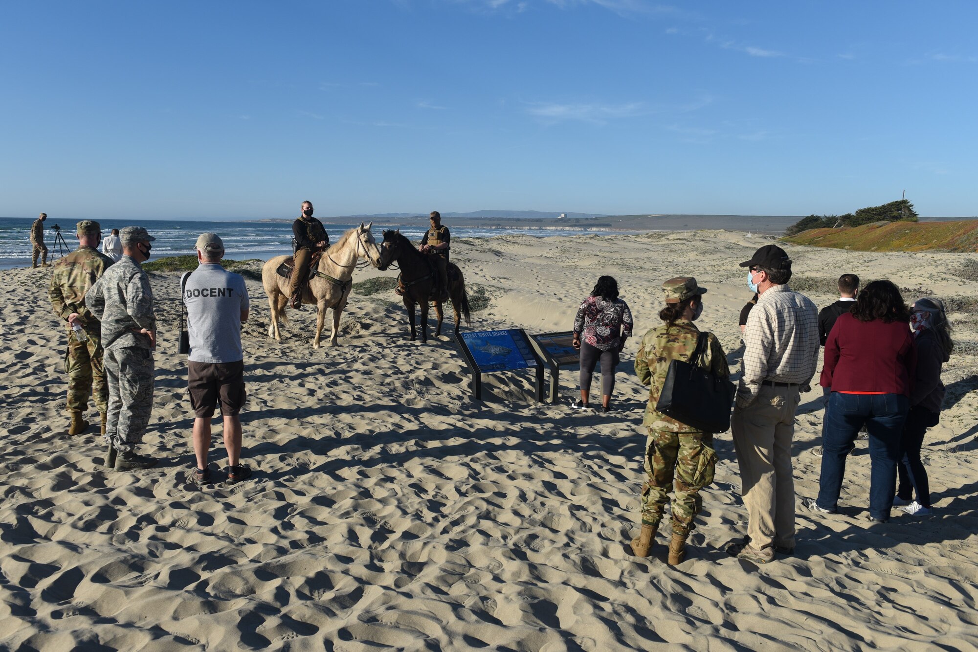 “Meet Surf Beach” attendees discuss the start of Snowy Plover nesting season beside updated educational signage on Vandenberg property.