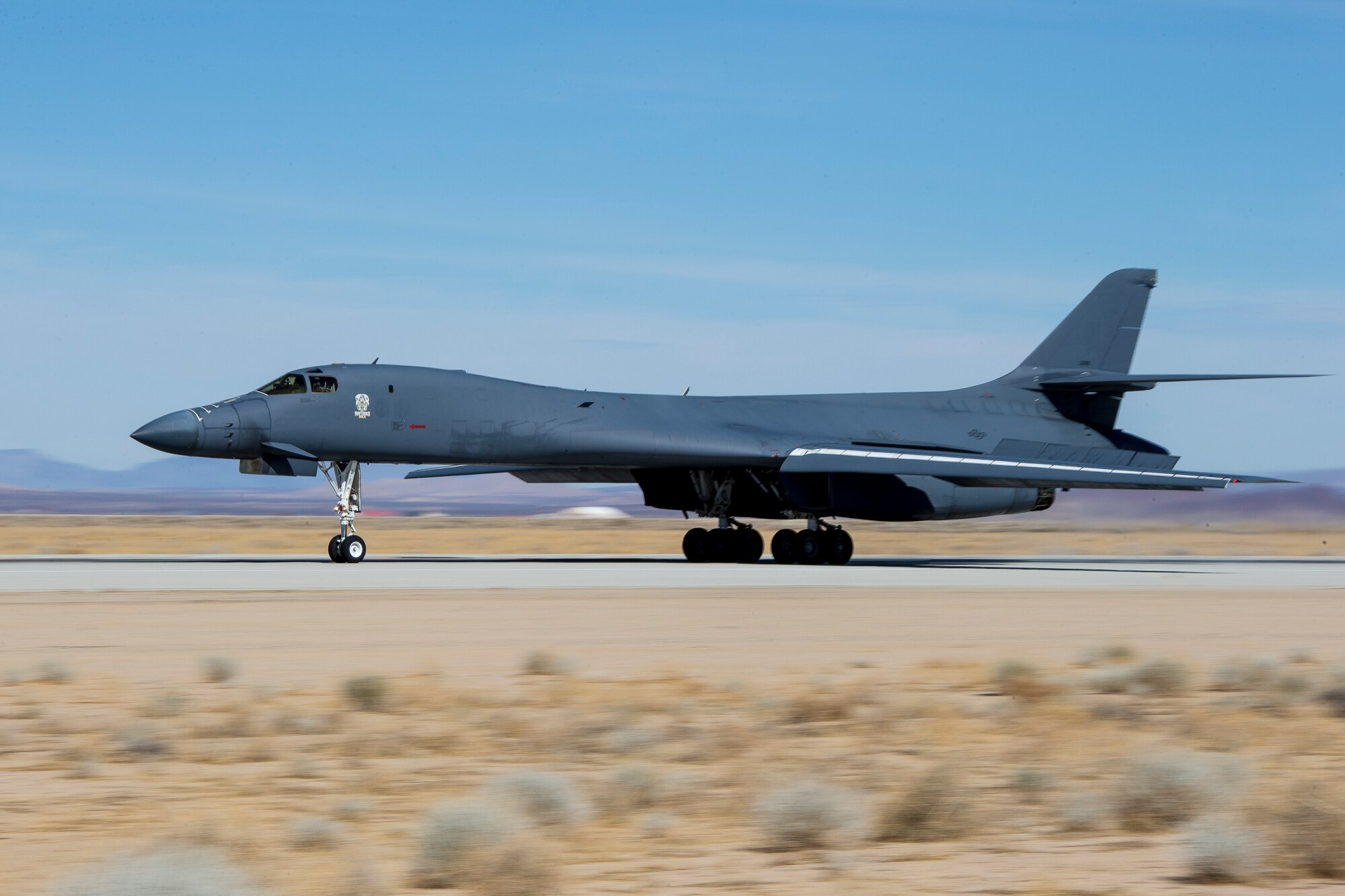 A recently retired B-1B Lancer, tail number 86-0099, lands at Edwards Air Force Base, California, Feb. 23. The aircraft will become the Edwards Aircraft Ground Integration Lab, or EAGIL, a non-flyable aircraft that will be used as an integration lab for future upgrades. (Air Force photo by May Straight)