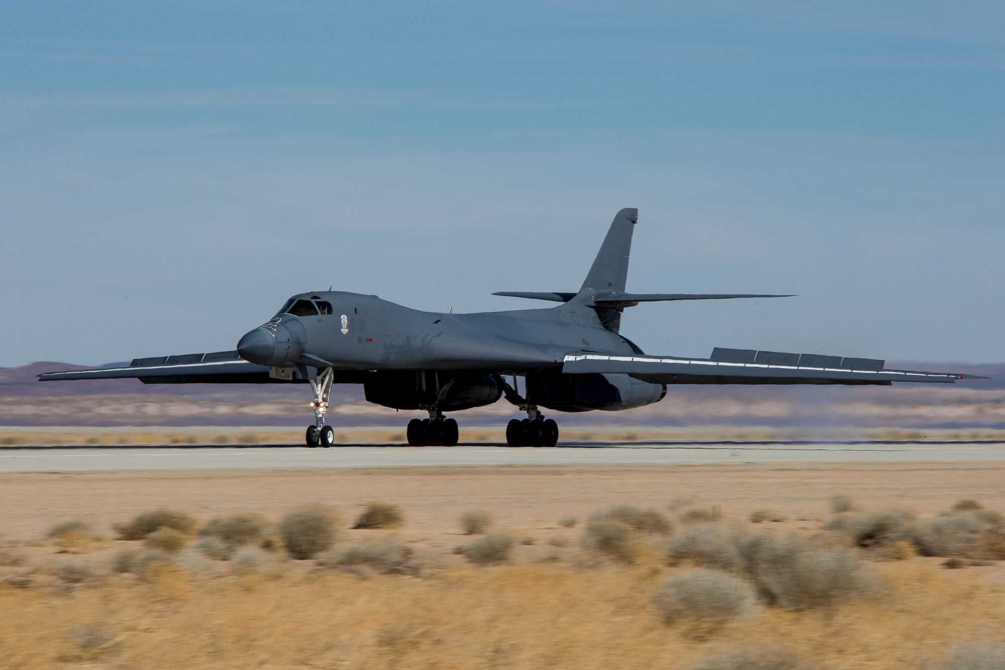 A recently retired B-1B Lancer, tail number 86-0099, lands at Edwards Air Force Base, California, Feb. 23. The aircraft will become the Edwards Aircraft Ground Integration Lab, or EAGIL, a non-flyable aircraft that will be used as an integration lab for future upgrades. (Air Force photo by May Straight)