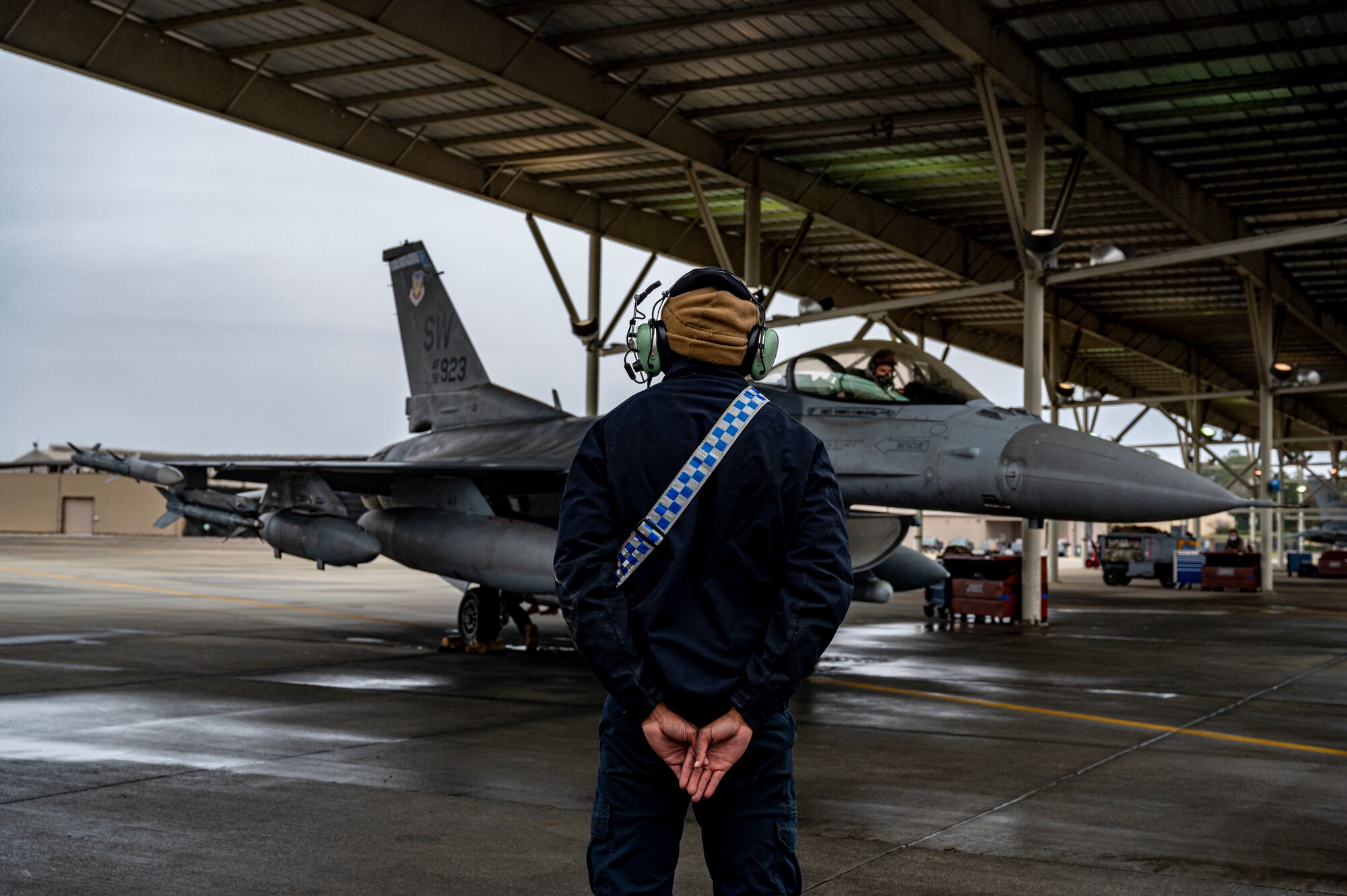 A photo of an Airman standing in front of a jet.