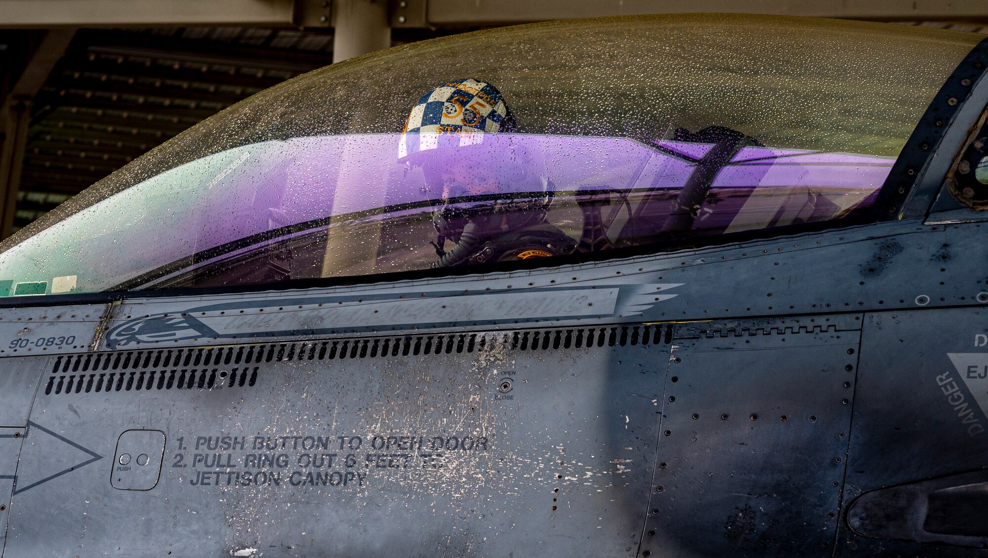 A photo of a pilot in the cockpit of an F-16.