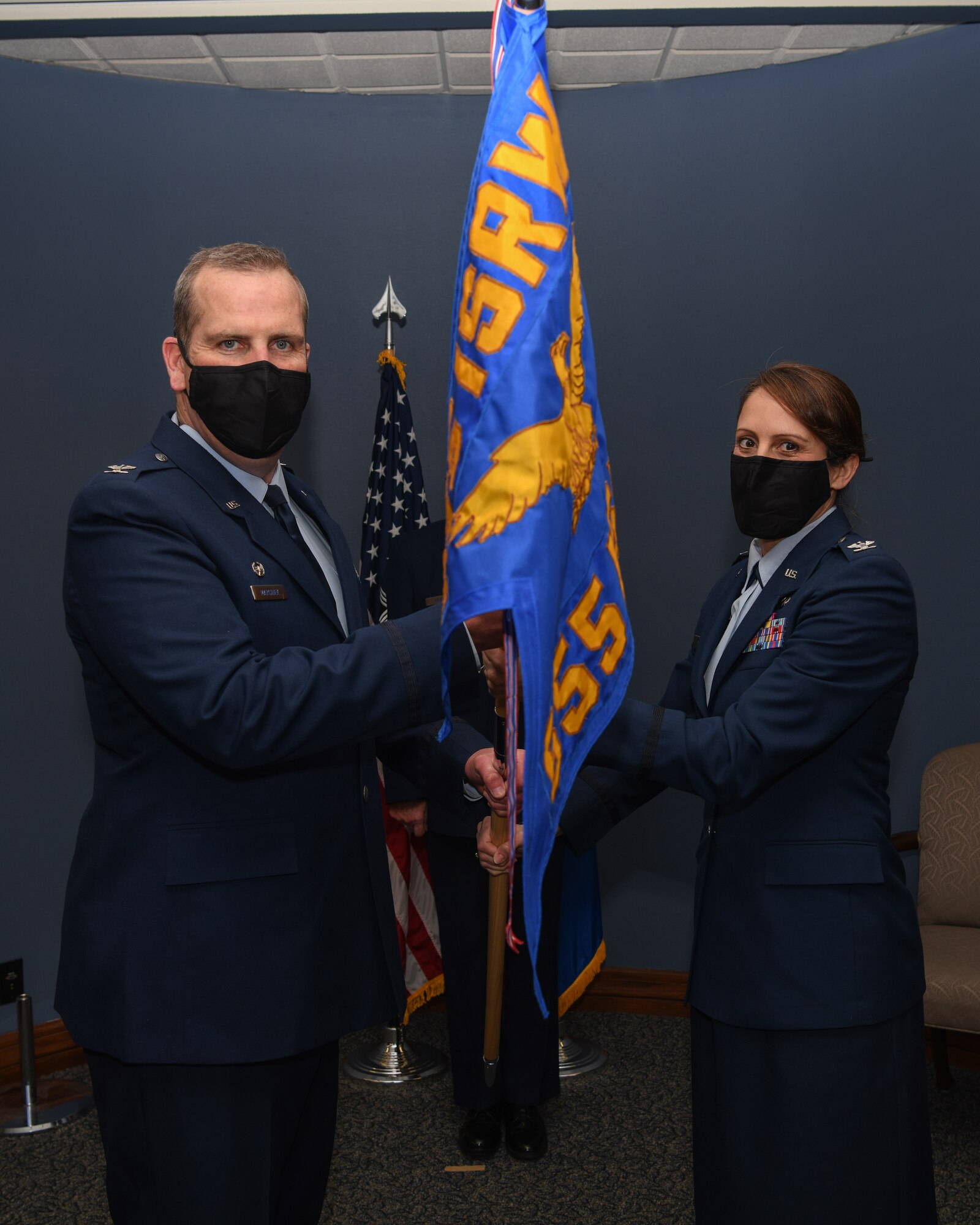 Incoming 655th Intelligence, Surveillance and Reconnaissance Group commander Col. Jennifer Mulder takes the guidon from Col. Joseph Marcinek, 655th Intelligence, Surveillance and Reconnaissance Wing commander, during an assumption of command ceremony held here Feb. 19, 2021. Colonel Mulder recently served as the Individual Mobilization Augmentee to the Commander, Joint Intelligence Operations Center, U.S. Indo-Pacific Command, Pearl Harbor, Hawaii. (U.S. Air Force photo/Mr. Patrick O’Reilly)
