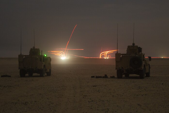 Marines in joint light tactical vehicles assigned to Combined Anti-Armor Team 3, 15th Marine Expeditionary Unit, provide machine gun suppression in support of a company non-illuminated night attack exercise during a theater amphibious combat rehearsal (TACR) at Camp Buehring, Kuwait, Feb. 22.