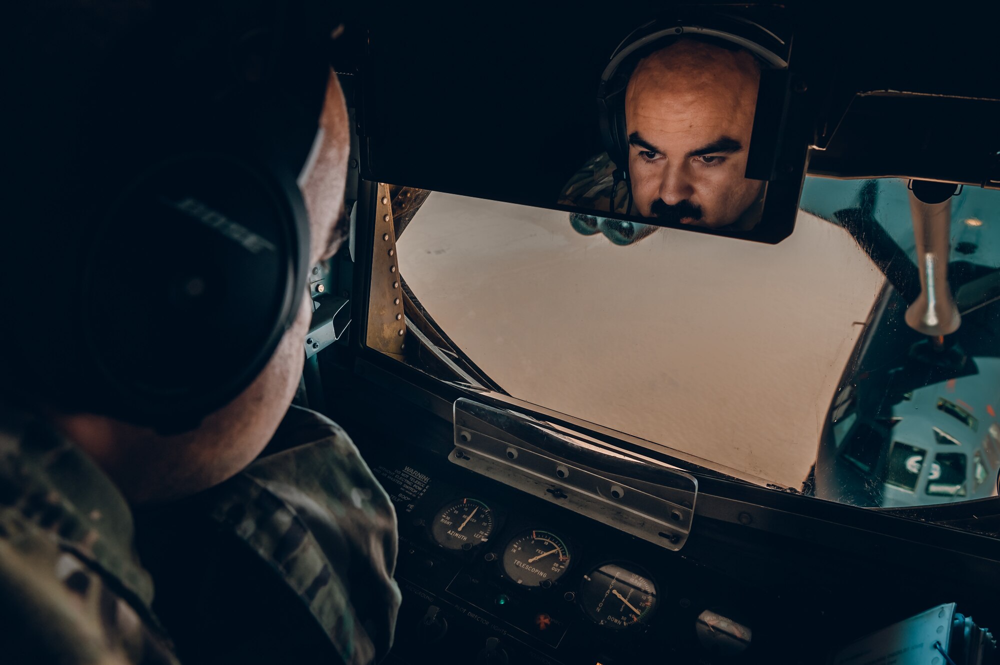 A U.S. Air Force KC-135 Stratotanker aircraft in-flight refueling specialist, assigned to the 350th Expeditionary Air Refueling Squadron, refuels a U.S. Air Force B-52 Stratofortress aircraft from the 5th Bomb Wing, Minot Air Force Base, ND, during a bomber task force mission over the U.S. Central Command area of responsibility, March 7, 2021.