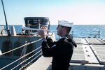 210304-N-RG171-0337 MEDITERRANEAN SEA (Mar. 4, 2021) Yeoman 3rd Class Mark Martinez plays “Taps” during a burial-at-sea aboard the Arleigh Burke-class guided-missile destroyer USS Donald Cook (DDG 75), Mar. 4, 2021. Donald Cook, forward-deployed to Rota, Spain, is on patrol in the U.S. Sixth Fleet area of operations in support of regional allies and partners and U.S. national security in Europe and Africa. (U.S. Navy photo by Machinist’s Mate 1st Class Peter Stitzel/Released)