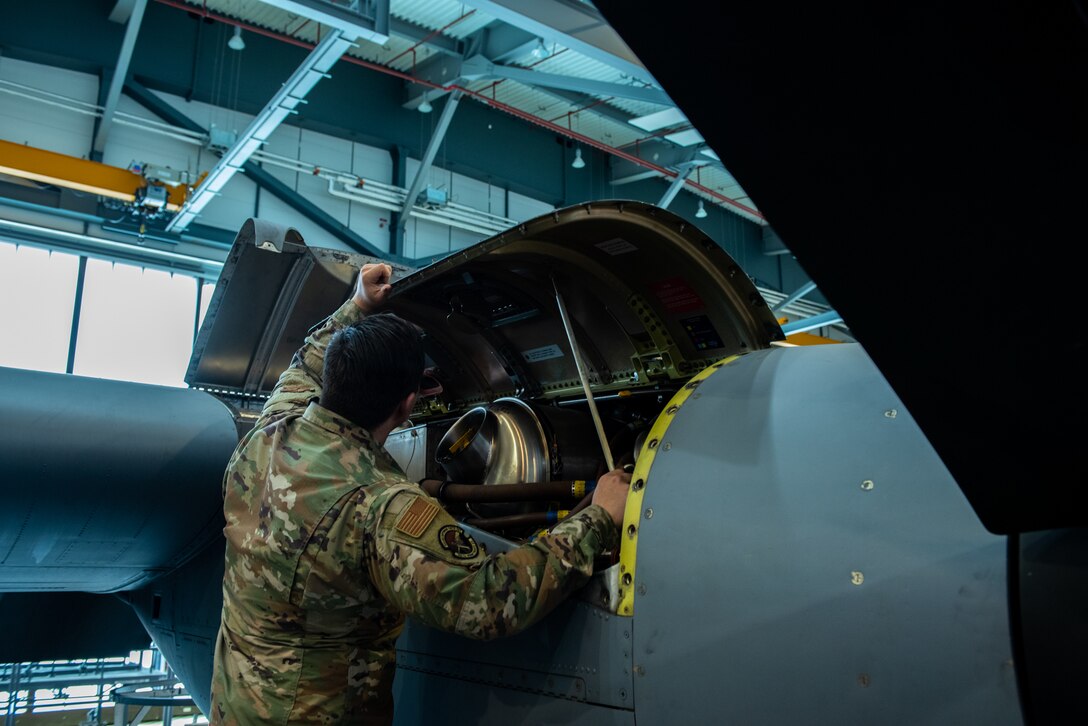 U.S. Air Force Airman 1st Class Ryan Hubbs, 86th Maintenance Squadron fuel cell technician, prepares to secure panels on a C-130J Super Hercules aircraft engine