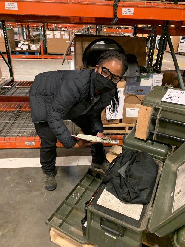 Shontavia Ortega examining items in a warehouse