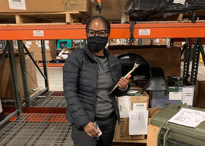 Shontavia Ortega examining items in a warehouse