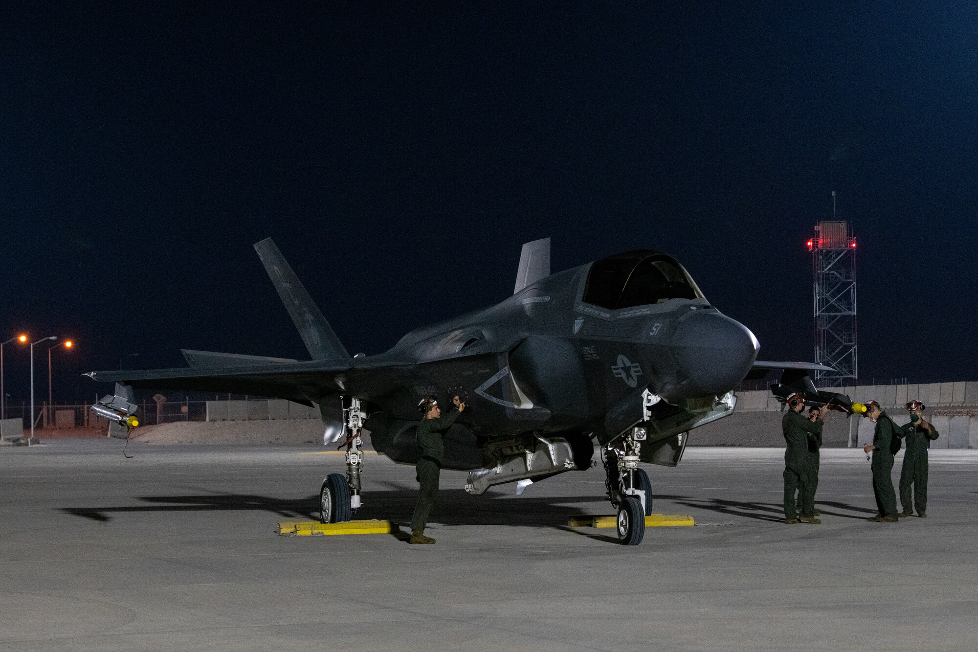 U.S. Marines prepare to launch an F-35B Lightning II aircraft, assigned to the Marine Medium Tiltrotor Squadron 164 (Reinforced), 15th Marine Expeditionary Unit, by conducting a foreign object debris clearance walk at Al Udeid Air Base, Qatar, March 3, 2021.