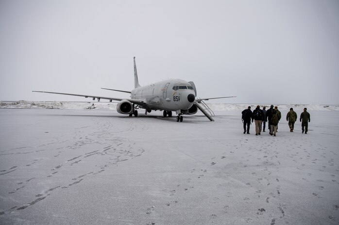 U.S. and Iceland service members and officials approach a P-8 Poseidon.