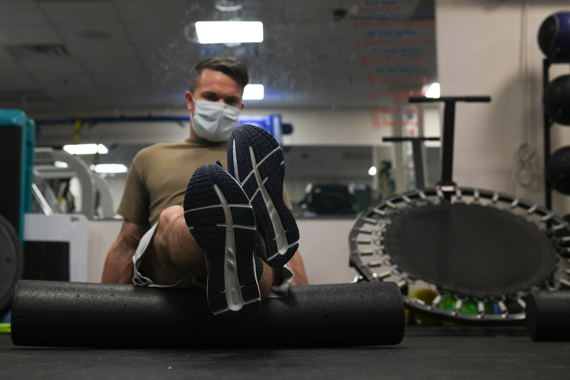 Tech. Sgt. David Ferricher, 22nd Maintenance Squadron metals technician, foam rolls his hamstrings Mar. 3, 2021, at McConnell Air Force Base, Kansas. The benefits of foam rolling include enhanced joint range of motion, delayed onset of fatigue and accelerated post recovery. (U.S. Air Force photo by Senior Airman Nilsa Garcia)