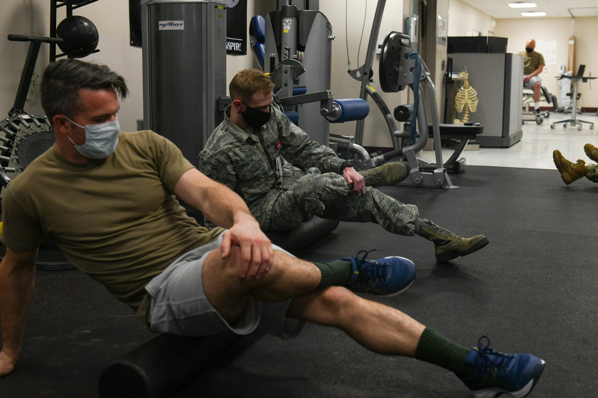 TSgt David Ferricher, 22nd Maintenance Squadron metals technician, and Senior Airman Heath Martin, 22nd Medical Operations Squadron physical therapy technician, uses a foam roller FOR their piriformis muscles Mar. 3, 2021, at McConnell Air Force Base, Kansas. Over the course of 30-45 minutes, participants in the class had the opportunity to execute and learn 12 foam rolling techniques. (U.S. Air Force photo by Senior Airman Nilsa Garcia)