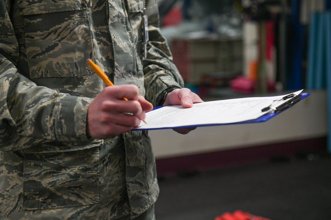 Senior Airman Heath Martin, 22nd Medical Operations Squadron physical therapy technician, records data Mar. 3, 2021, at McConnell Air Force Base, Kansas. The sheet provides an overall assessment of the patient’s session that can be referred to by physical therapy technicians when an Airmen comes in for future classes. (U.S. Air Force photo by Senior Airman Nilsa Garcia)