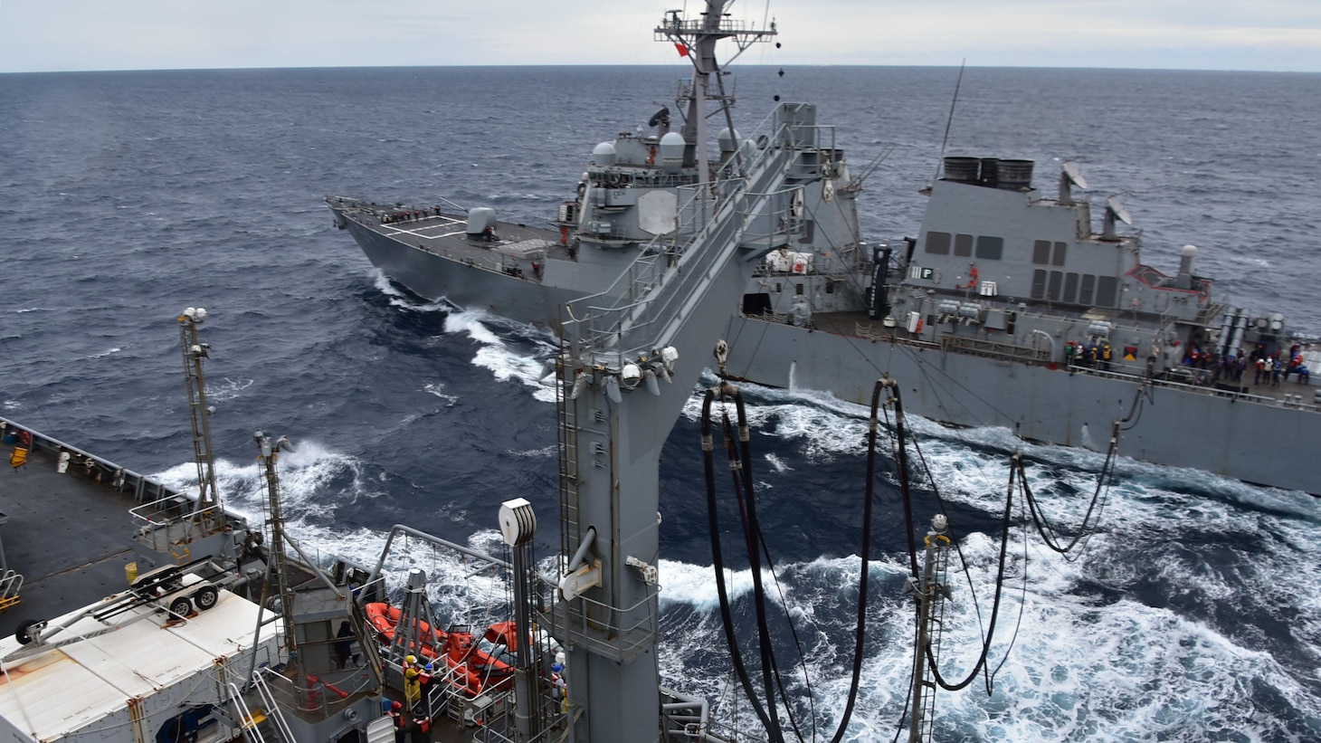 The fleet replenishment oiler USNS Tippecanoe (T-AO 199) conducts a replenishment at sea with USS Curtis Wilbur (DDG 54), an Arleigh Burke-class guided missile destroyer.  Tippecanoe and other ships in Military Sealift Command Far East’s combat logistics force keep U.S. and international partners’ ships operating in the Indo-Pacific Region supplied with all the essentials, including food, fuel, spare parts, and all the fixings for a traditional Thanksgiving meal. (U.S. Navy photo by Christopher Bosch)