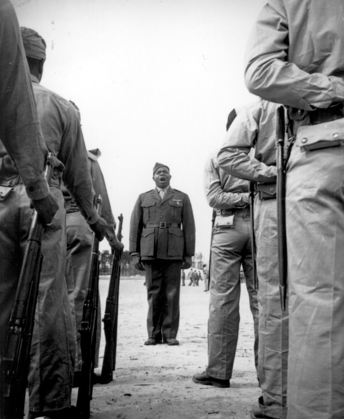 A platoon of black "boot recruits" listen to their drill instructor, Sgt. Gilbert Hubert Johnson, whose job is to turn them into finished Marines at Montford Point, Camp Lejeune, N.C., April 1943.