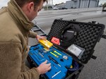 Senior Airman Brandon Williams, 187th Fighter Wing crew chief, selects tools from a pelican case in preparation for the arrival of an F-16 in Dothan, Ala., March 3, 2021. Airmen and aircraft from Dannelly Field participated in a training exercise that tested their ability to rapidly deploy to a simulated austere location.