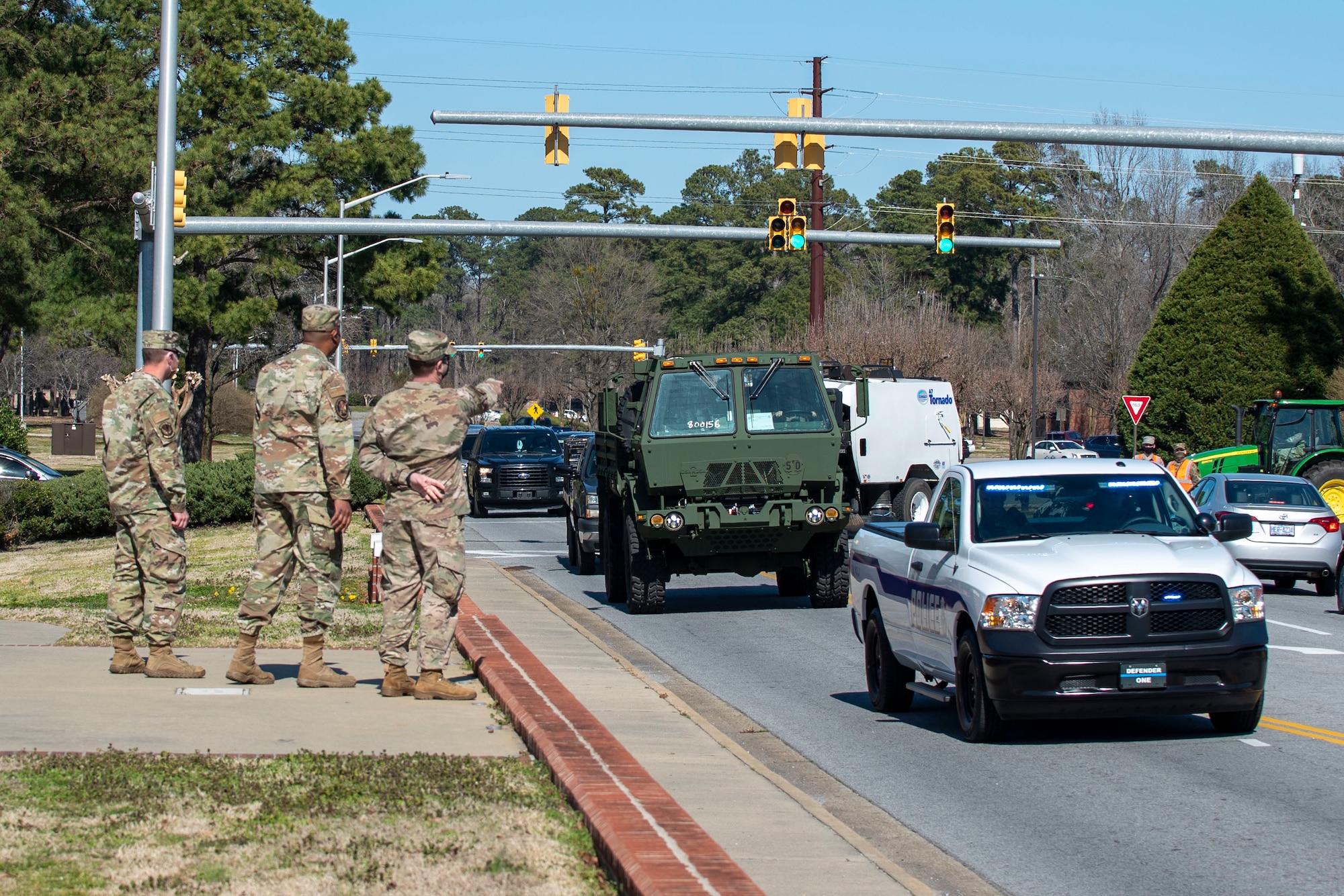 Leadership from the 4th Mission Support Group watch vehicles drive by during a Vehicle Inspection Roll-By competition at Seymour Johnson Air Force Base, North Carolina, March 8, 2021.