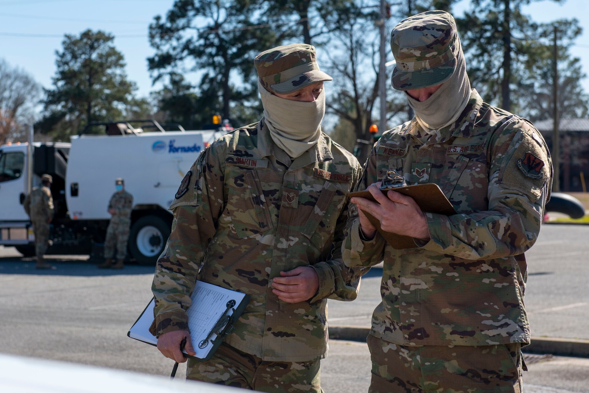 Airmen from the 4th Logistics Readiness Squadron use a check list to grade vehicles during a Vehicle Inspection Roll-By competition at Seymour Johnson Air Force Base, North Carolina, March 8, 2021.