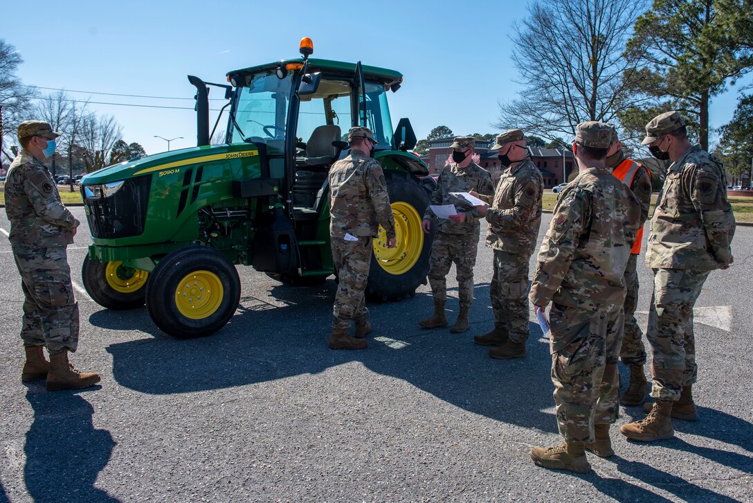 Airmen from the 4th Logistics Readiness Squadron grade a tractor during a Vehicle Inspection Roll-By competition at Seymour Johnson Air Force Base, North Carolina, March 8, 2021.