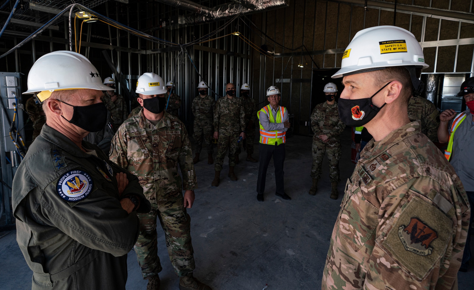 Kelly and Timothy speak with each other as other watch on at the construction site.