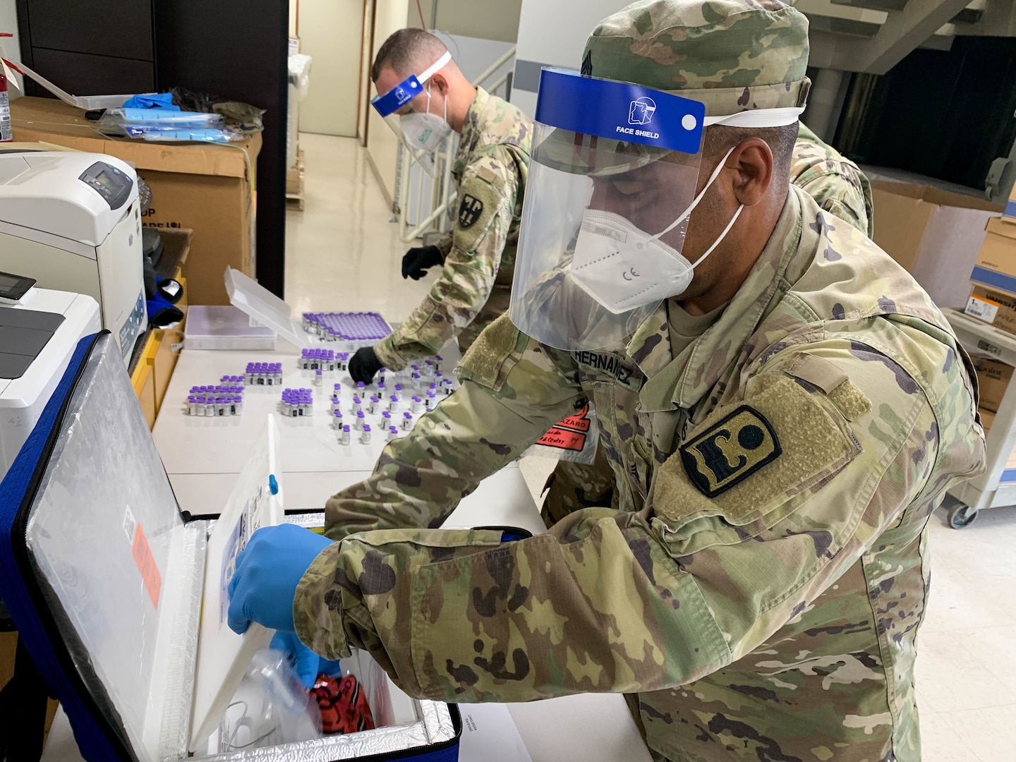 Sgt. Javier Hernández from Joint Task Force - Puerto Rico prepares COVID-19 vials for distribution in Ponce Jan. 19, 2021. The PRNG continued with the COVID-19 vaccine distribution process for Operation Warp Speed to support the Department of Health and the Centers for Disease Control and Prevention.