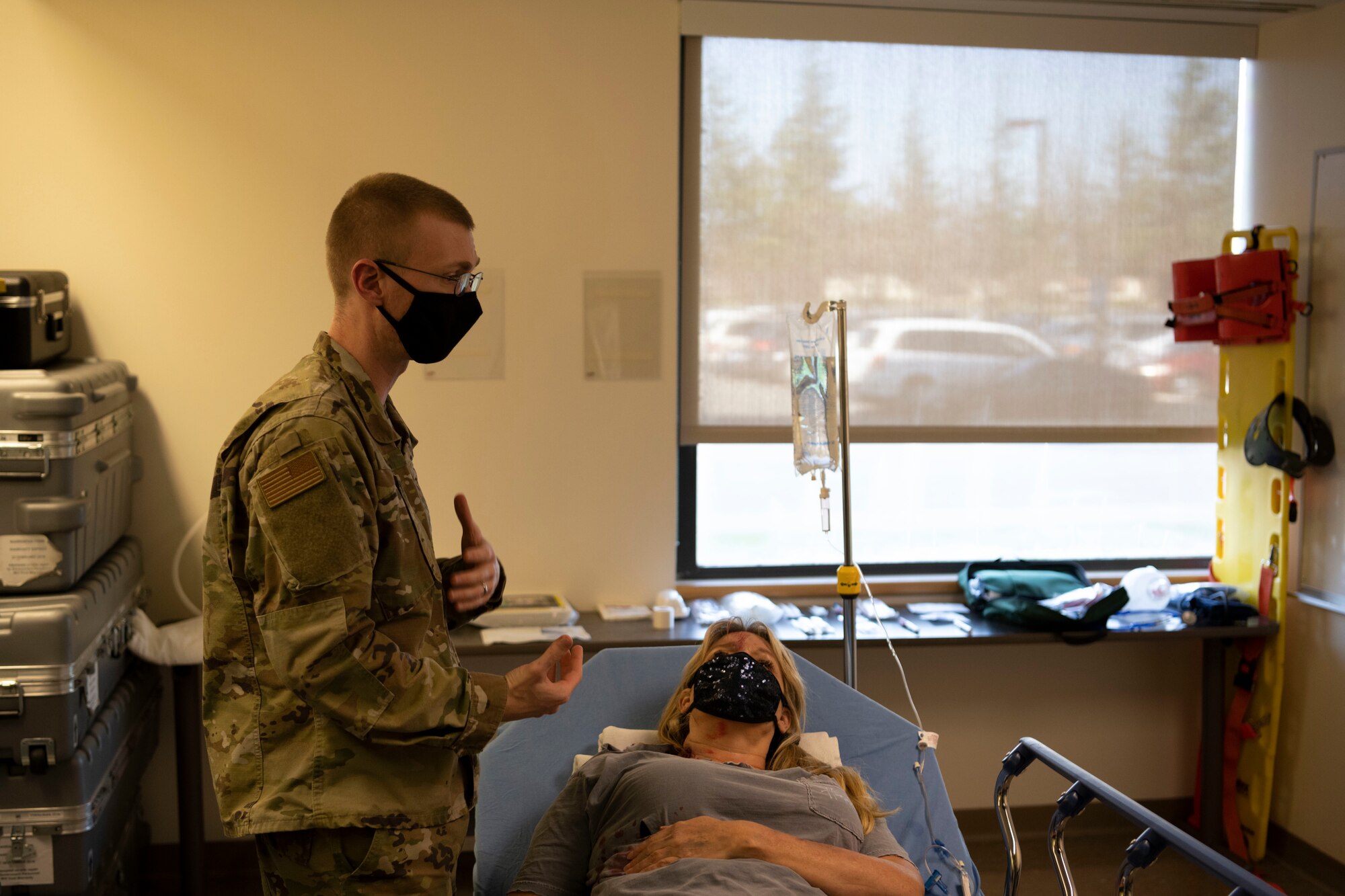 U.S. Air Force Capt. Norman Hurst, 60th Healthcare Operation Squadron, family medicine resident, assesses patient Marika Leegwater, a moulage model, during Advanced Trauma Life Support training March 4, 2021, at Travis Air Force Base, California. ATLS equips different specialties in the medical field with the skills to treat traumatic injuries. (U.S. Air Force photo by Airman 1st Class Alexander Merchak)