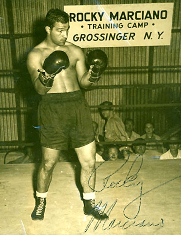 A boxer poses for a photo.