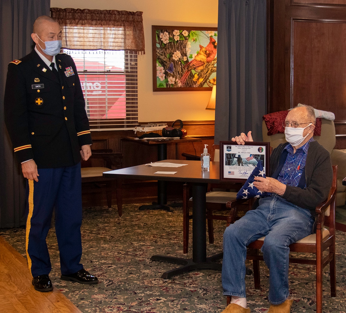 William Hills of Freeport, Illinois, shows off the U.S. flag and certificate presented by Lt. Col. Eric Smith of Springfield, Illinois, in honor of Hills’ 97th birthday Jan. 29.