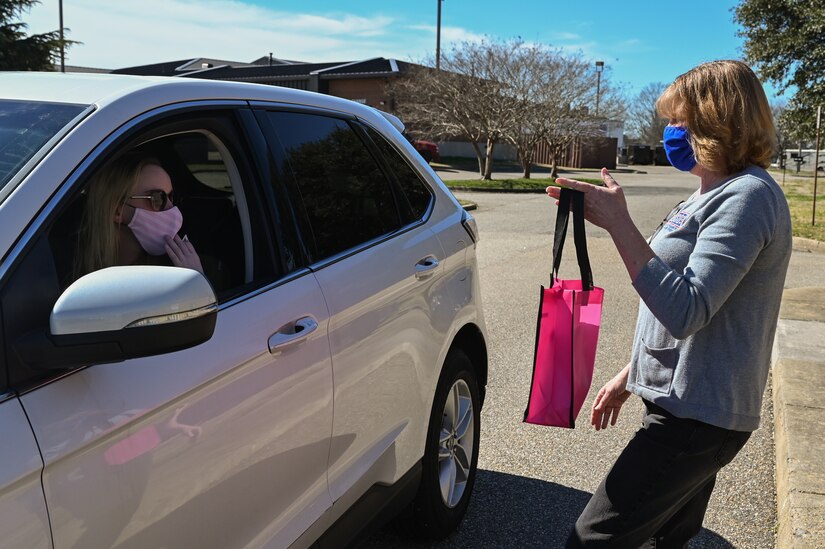 Diane Fry, USO of Hampton Roads and Central Virginia center director, gives away a self-care package to a participant during a drive-by pickup at the USO at Joint Base Langley-Eustis, Virginia, March 3, 2021.