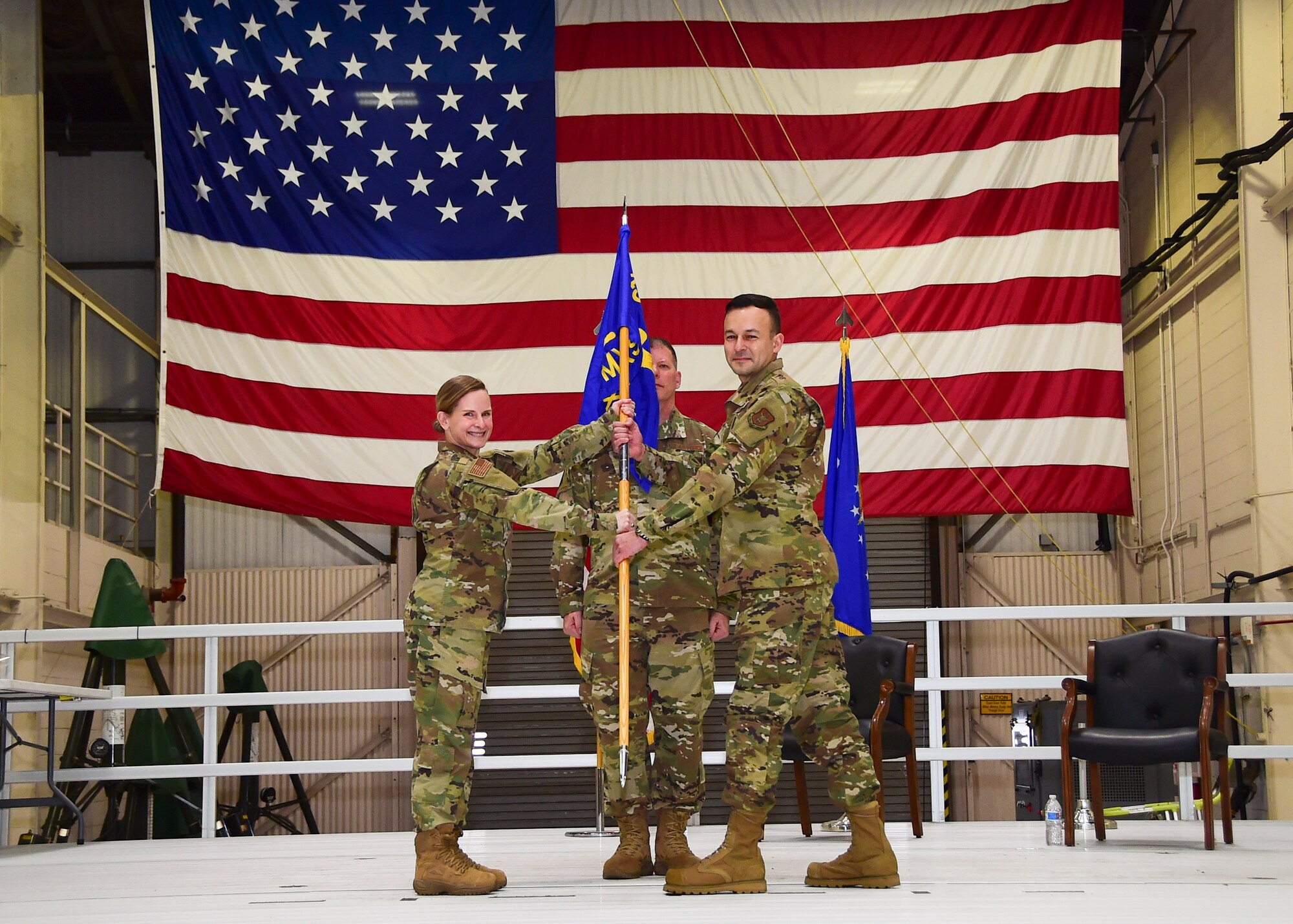 Col. Arianne Mayberry, 434th Maintenance Group commander, passes the guidon to Maj. Bradley Palm, 434th Maintenance Squadron commander, during an assumption of command ceremony at Grissom Air Reserve Base, Ind. Feb. 7, 2021. Palm assumed command of the 434th MXS from Lt. Col. Nicole Fink. (U.S. Air Force photo by Staff Sgt. Chris Massey)