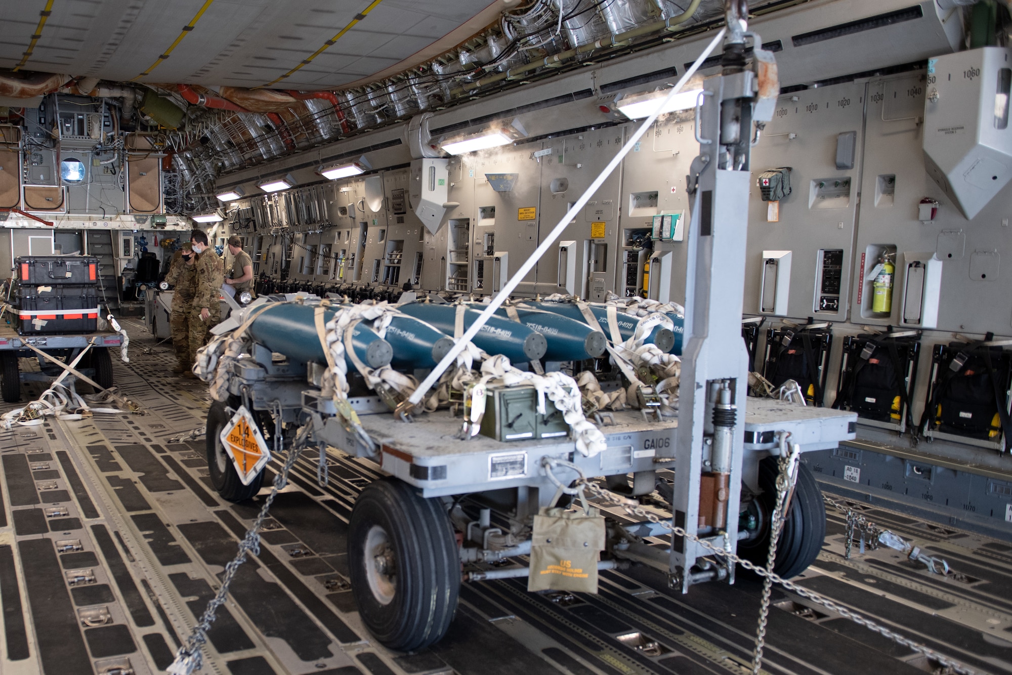 A photo of a munitions trailer on an aircraft