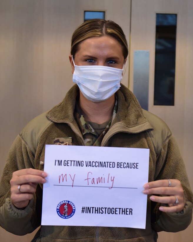 U.S. Air Force Senior Arm. Emma Niese, assigned to the Ohio Air National Guard's 178th Wing Logistics Readiness, holds a sign depicting her reason for getting the COVID-19 vaccine March 3, 2021 on base in Springfield, Ohio.