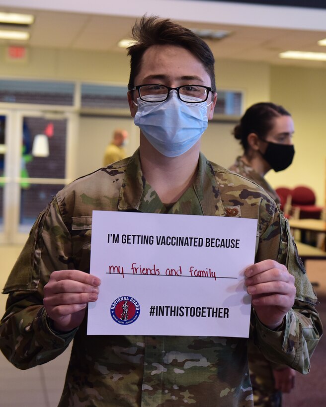 U.S. Air Force Airman Sean Buck, assigned to the Ohio Air National Guard's 178th Wing Logistics Readiness, holds a sign depicting his reason for getting the COVID-19 vaccine, March 3, 2021 on base in Springfield, Ohio.