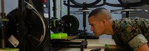 U.S. Marine Corps Cpl. Michael Espinosa with Makerspace, 2nd Marine Logistics Group monitors 3-D printing of face masks on Camp Lejeune, North Carolina, March 30, 2020. Marines from Makerspace utilized 3-D printing to rapidly manufacture personal protective equipment to be sent to aid FEMA Region 8 and 2nd Medical Battalion in COVID-19 screening. (U.S. Marine Corps photo by Lance Cpl. Scott Jenkins)