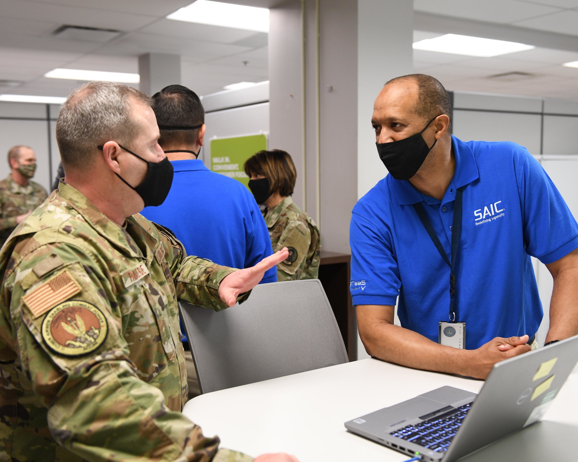 Brig. Gen. Chad Raduege, Cyberspace and Information Dominance director, and Headquarters Air Combat Command Chief Information Officer, discusses capabilities of the new Tech Café with Eric Akrie, an AL2 technician with the Enterprise Information Technology as a Service, at Buckley Air Force Base, Colo., March 8, 2021. A ribbon cutting ceremony was held to signify the opening of the U.S. Air Force’s first Tech Café. (U.S. Space Force photo by Airman 1st Class Haley N. Blevins)