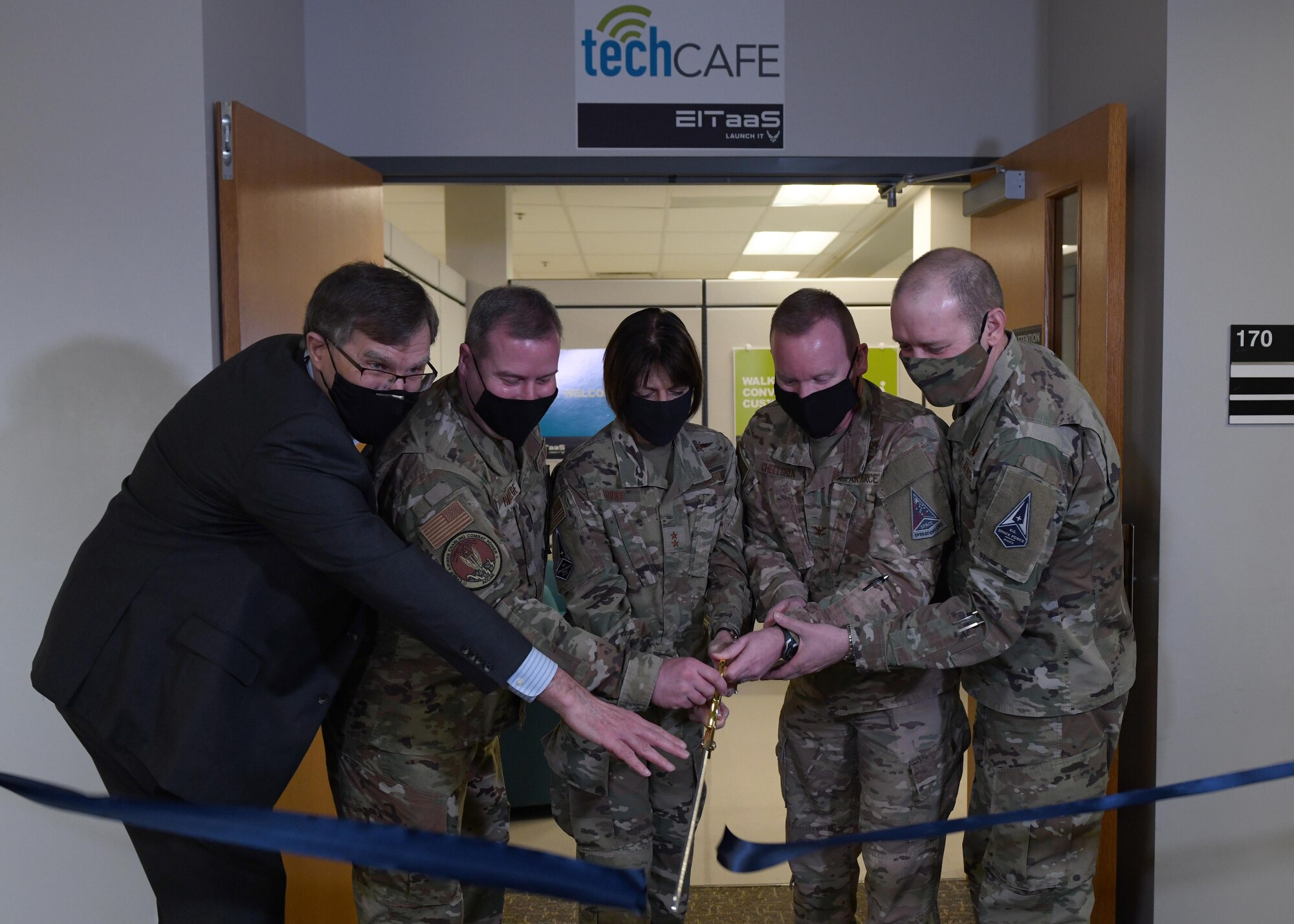 From left to right, Vincent DiFronzo, Science Applications International Corporation operations vice president; Brig. Gen. Chad Raduege, Cyberspace and Information Dominance director, and Headquarters Air Combat Command Chief Information Officer; Maj. Gen. Kimberly Crider, Headquarters United States Space Force mobilization assistant to the Chief of Space Operations; Col. Brian Chellgren, Buckley Garrison acting commander; and Brig. Gen. Douglas Schiess, Headquarters Space Operations Command Space and Cyber Operations director, cut a ribbon at the entrance of the Tech Café at Buckley Air Force Base, Colo., March 8, 2021. The Tech Café technicians are able to assist with numerous information technology related issues including: device support, hardware repair drop-off, application support, computer installation support and system imaging. (U.S. Space Force photo by Airman 1st Class Haley N. Blevins)