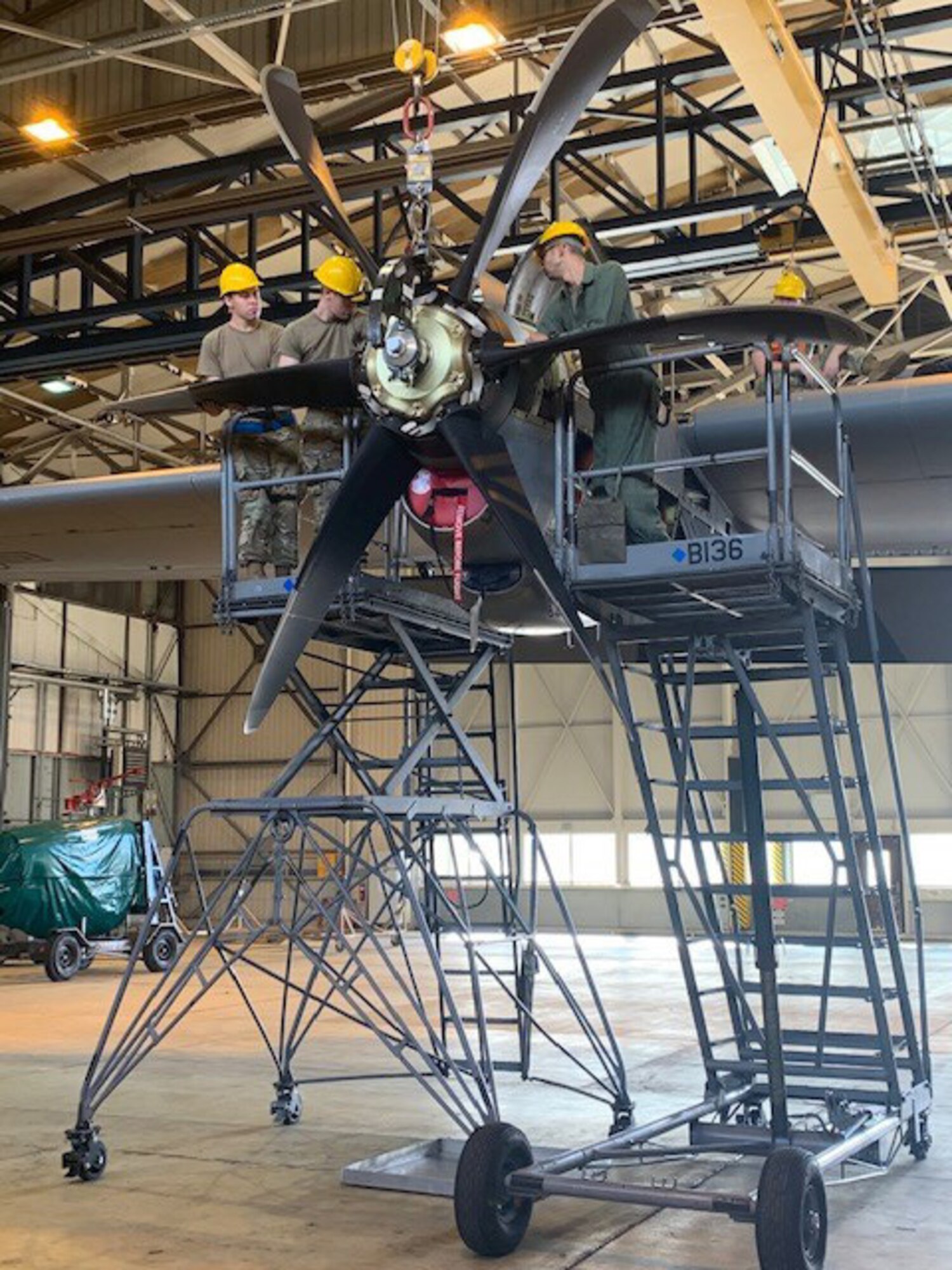 U.S. Air Force Airmen assigned to the 86th Maintenance Squadron and the 86th Aircraft Maintenance Squadron work together to remove a C-130J Super Hercules aircraft propeller during major maintenance procedures