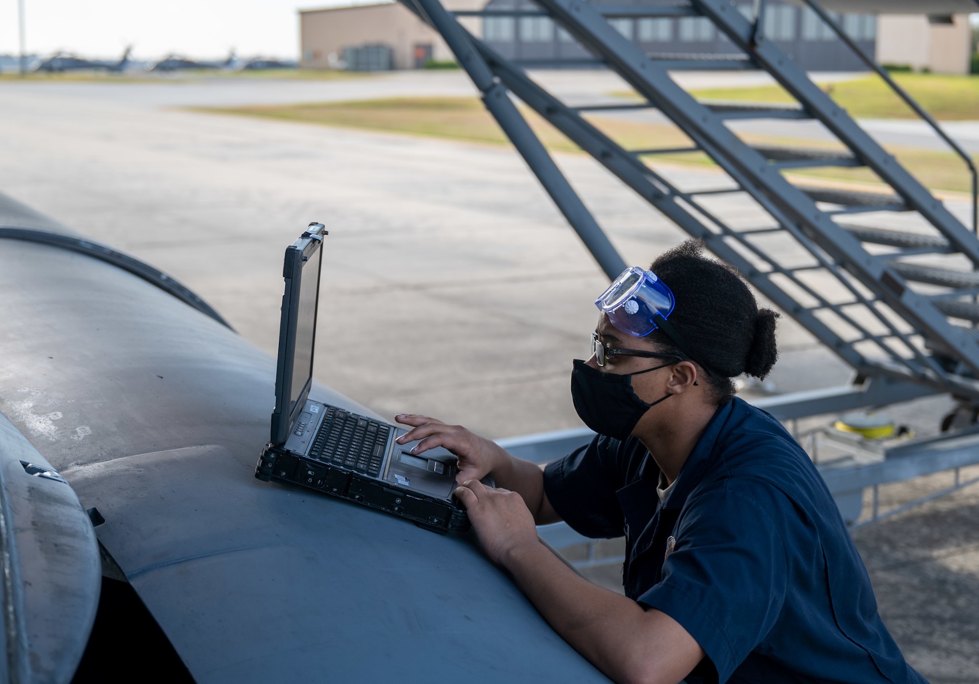Airman 1st Class Adrienne Jones, 436th Maintenance Squadron fuels journeyman, researches maintenance solutions next to a Dover Air Force Base C-17 Globemaster III at Moody AFB, Georgia, Feb, 28, 2021. Aircrew from the 3rd Airlift Squadron identified a faulty plug housing on the C-17 following the completion of Exercise Mosaic Tiger. A three-Airmen Maintenance Recovery Team from Dover AFB was alerted and mobilized within 24 hours. The MRT, along with the flying crew chief assigned to the C-17, coordinated parts and tools from Joint Base Charleston, South Carolina, to ensure the successful return of the aircraft to Dover AFB. (U.S. Air Force photo by Airman 1st Class Faith Schaefer)
