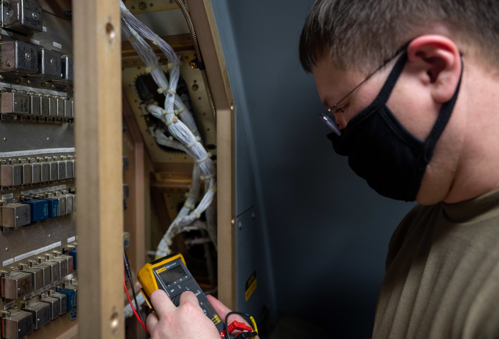 Tech. Sgt. Rian Meyer, 736th Maintenance Squadron electrical and environmental systems craftsman, tests voltage from an electricity panel on a Dover Air Force Base C-17 Globemaster III at Moody AFB, Georgia, Feb. 28, 2021. Aircrew from the 3rd Airlift Squadron identified a faulty plug housing on the C-17 following the completion of Exercise Mosaic Tiger. A three-Airmen Maintenance Recovery Team from Dover AFB was alerted and mobilized within 24 hours. The MRT, along with the flying crew chief assigned to the C-17, coordinated parts and tools from Joint Base Charleston, South Carolina, to ensure the successful return of the aircraft to Dover AFB. (U.S. Air Force photo by Airman 1st Class Faith Schaefer)