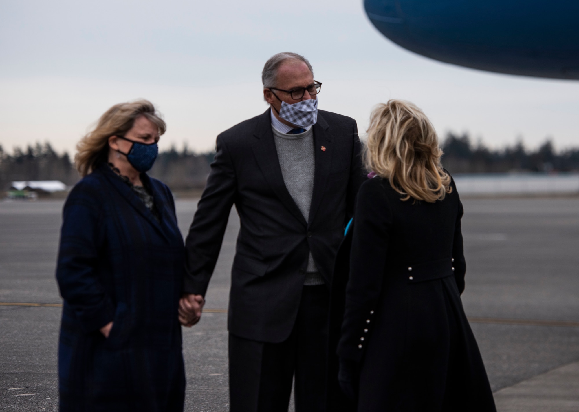First Lady Dr. Jill Biden is greeted by Jay Inslee, the governor of Washington, and his spouse, Trudee Inslee, at Joint Base Lewis-McChord, Washington, March 8, 2021. Biden visited with military families as part of an on-going effort to relaunch Joining Forces, an initiative to support service members, veterans and their families through wellness, education, and employment opportunities. (U.S. Air Force photo by Staff Sgt. Rachel Williams)