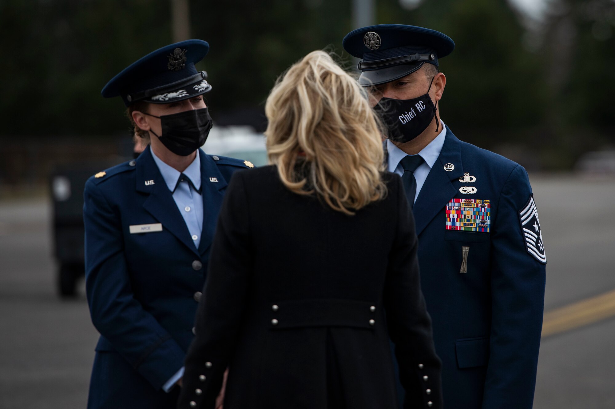 First Lady Dr. Jill Biden is greeted by U.S. Air Force Chief Master Sgt. Joe Arce, command chief with the 62nd Airlift Wing, and his spouse, U.S. Air Force Maj. Jennifer Arce, a flight medicine nurse with the 62nd Medical Squadron, at Joint Base Lewis-McChord, Washington, March 8, 2021. Biden visited with military families as part of an on-going effort to relaunch Joining Forces, an initiative to support service members, veterans and their families through wellness, education, and employment opportunities. (U.S. Air Force photo by Staff Sgt. Rachel Williams)